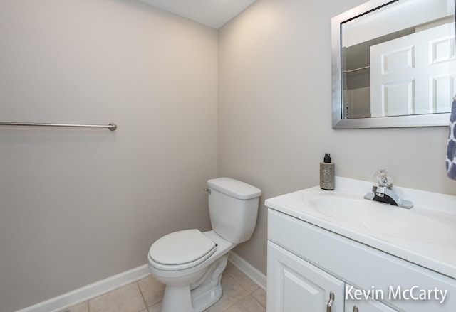 bathroom with vanity, tile patterned floors, toilet, and baseboards