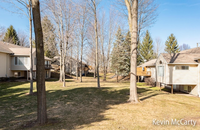 view of yard with a residential view and a wooden deck