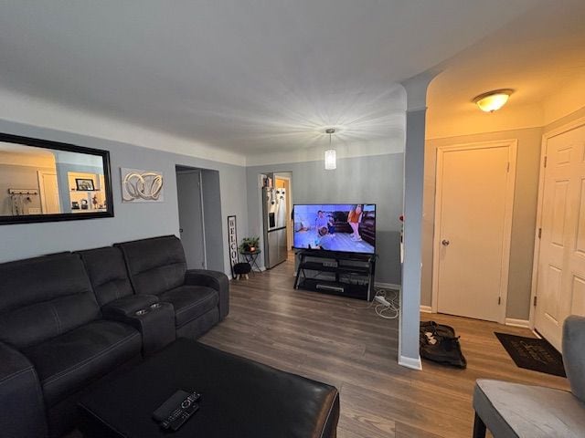 living room with baseboards and wood finished floors