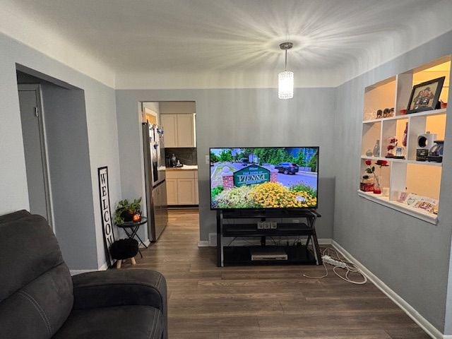 living room with baseboards and dark wood-style flooring