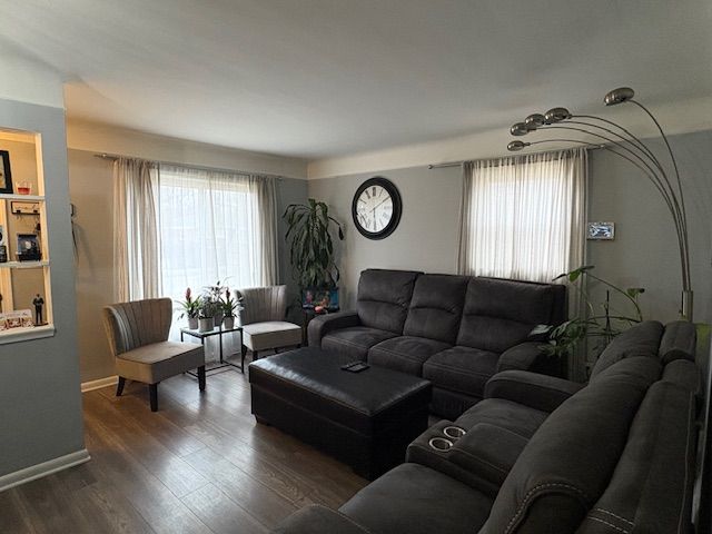 living area featuring baseboards and wood finished floors