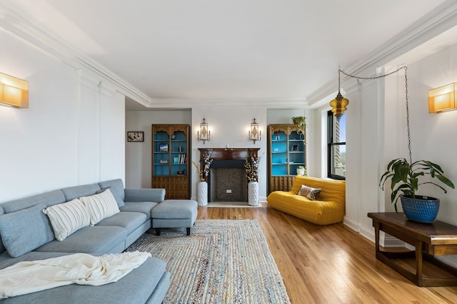 15 E Kirby St Unit 1104, Detroit, MI 48202 - living room with light wood-style flooring, a fireplace, crown molding, and baseboards