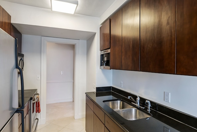 15 E Kirby St Unit 1104, Detroit, MI 48202 - kitchen featuring a sink, stainless steel electric range, freestanding refrigerator, dark countertops, and light tile patterned flooring