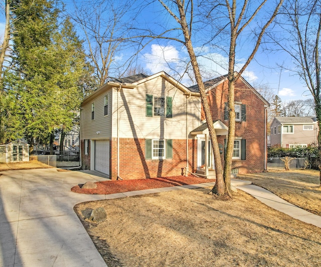 view of front of house with brick siding, an attached garage, driveway, and fence