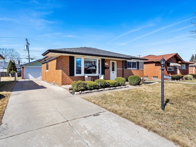 ranch-style house featuring a garage, an outbuilding, brick siding, and a front yard