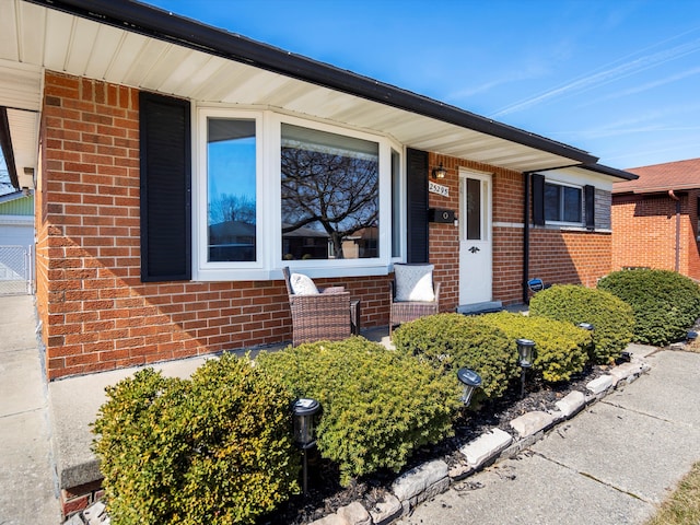 doorway to property featuring brick siding