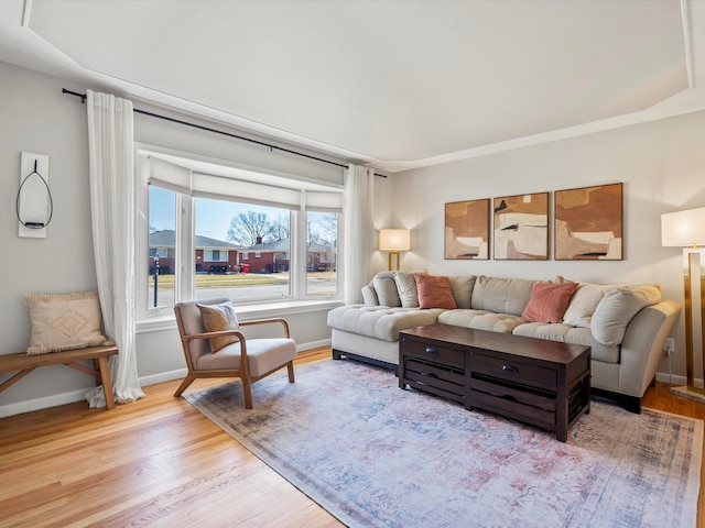 living area featuring baseboards and wood finished floors