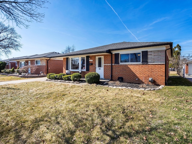 ranch-style house with brick siding and a front lawn