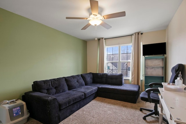 living area with a ceiling fan and carpet floors