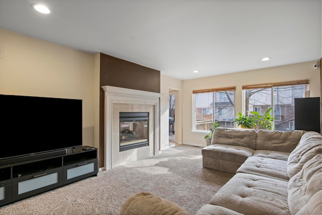 carpeted living room with a tiled fireplace, recessed lighting, and baseboards