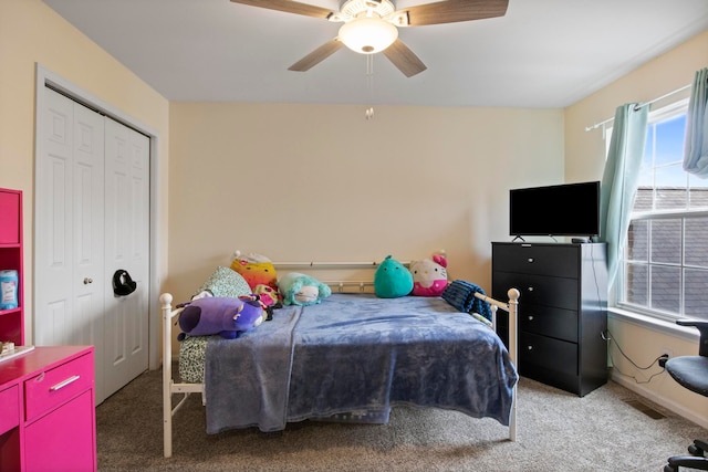 carpeted bedroom with visible vents, a closet, and ceiling fan