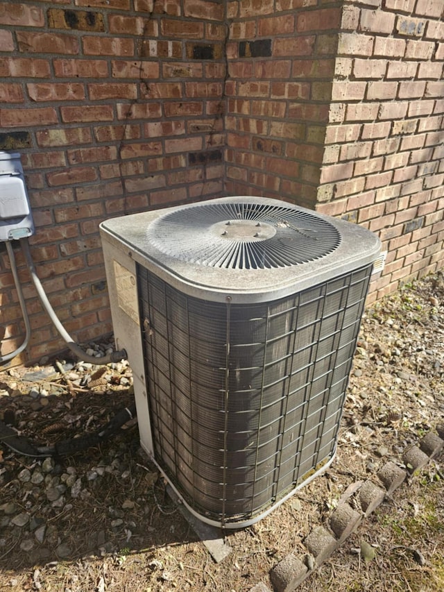 exterior details with central AC unit and brick siding