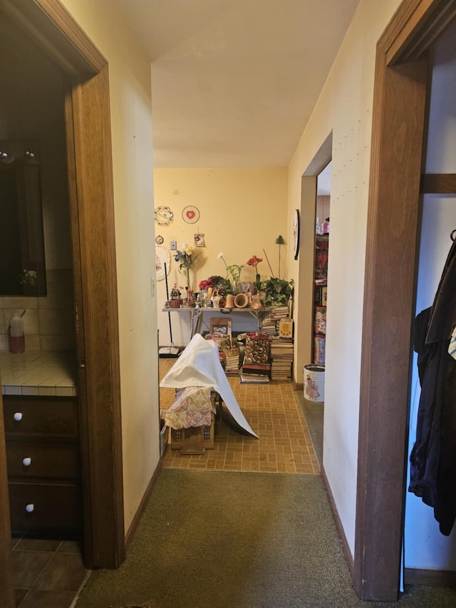 hallway with carpet and baseboards