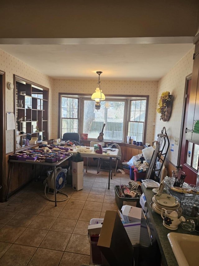 dining room featuring wallpapered walls and dark tile patterned floors