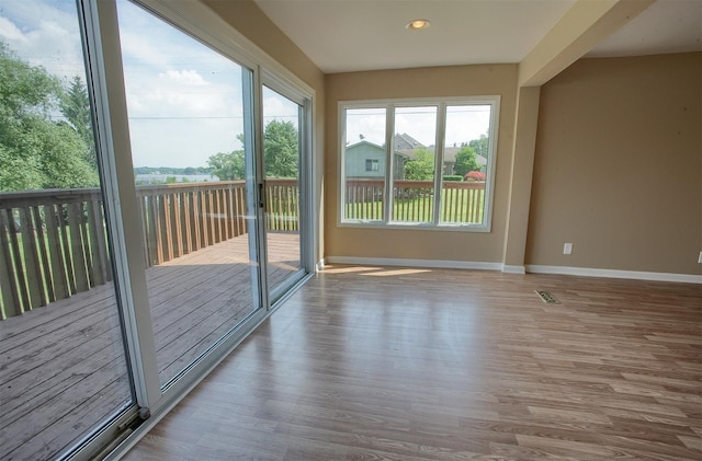 unfurnished sunroom with visible vents