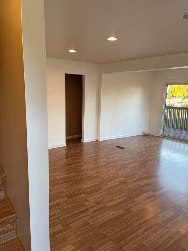 spare room featuring recessed lighting, wood finished floors, visible vents, and baseboards