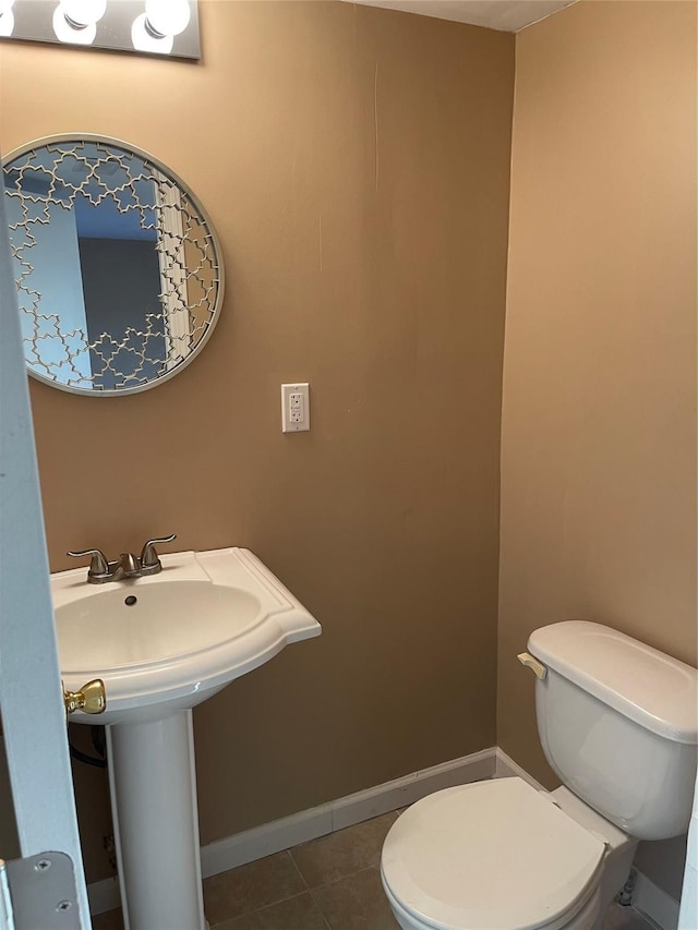 bathroom featuring tile patterned floors, toilet, and baseboards