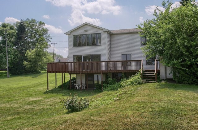 back of property featuring a lawn and a wooden deck