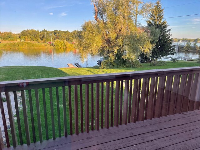 deck featuring a lawn and a water view