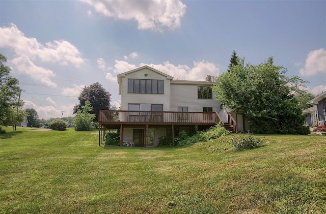 rear view of house featuring a deck and a yard