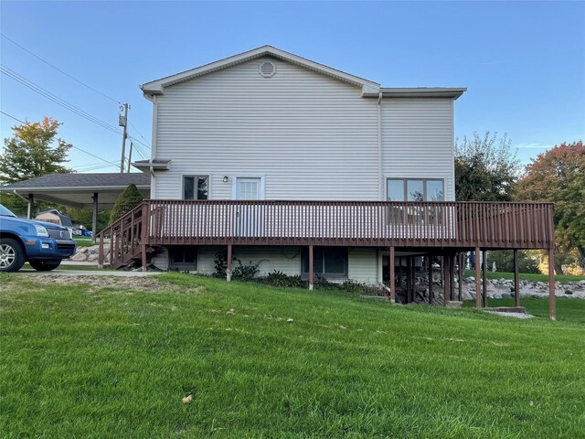 back of property featuring a yard and a wooden deck