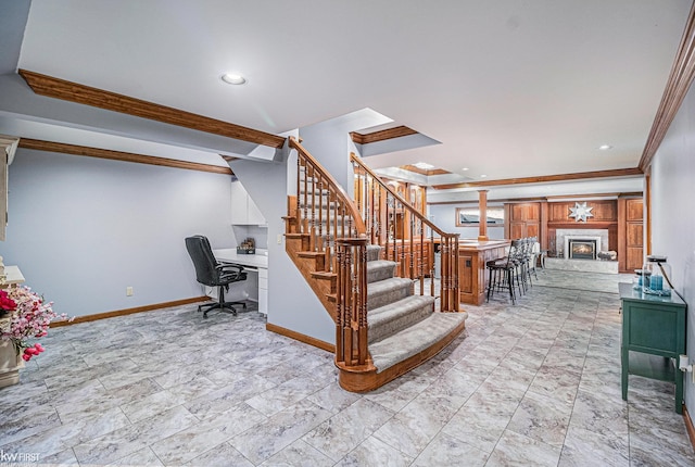 staircase with a glass covered fireplace, recessed lighting, crown molding, and baseboards