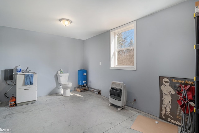 misc room with heating unit and concrete floors