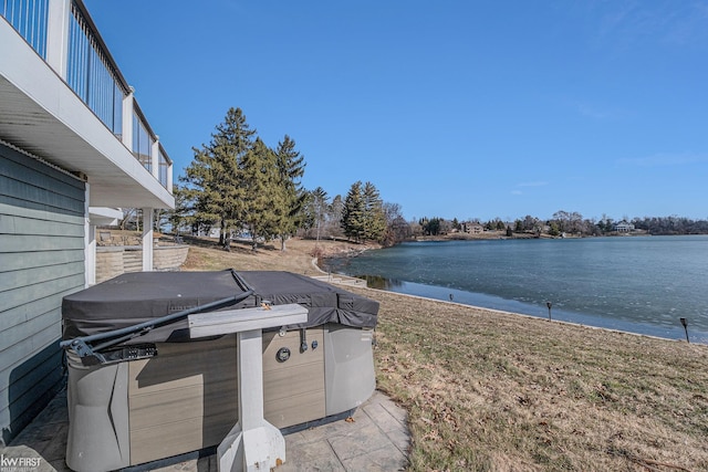 exterior space featuring grilling area and a water view