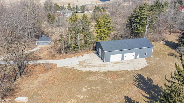 bird's eye view with a wooded view