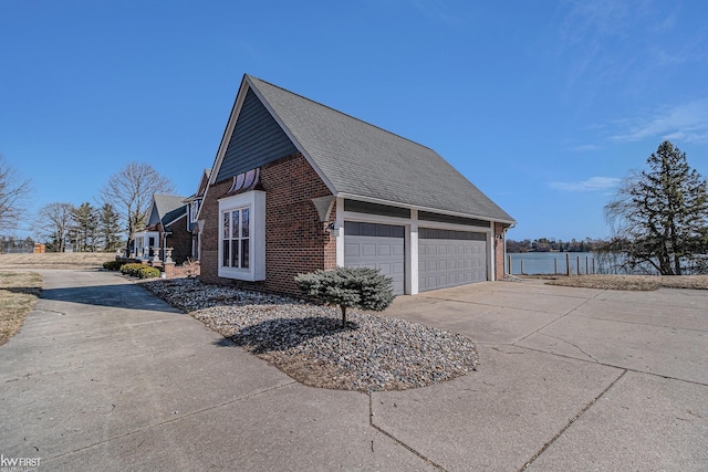 view of property exterior featuring brick siding, concrete driveway, and a shingled roof