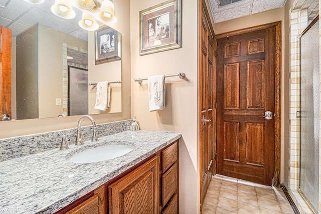 full bathroom with a stall shower, vanity, and tile patterned flooring