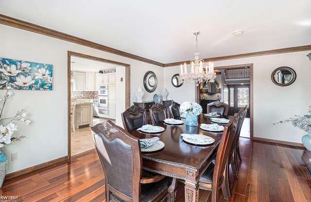 dining room featuring baseboards, wood finished floors, and crown molding