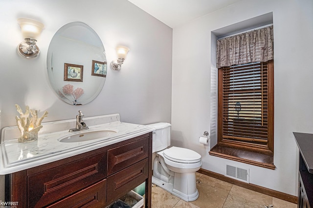 bathroom with visible vents, toilet, tile patterned flooring, baseboards, and vanity