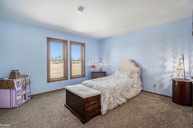 carpeted bedroom featuring baseboards