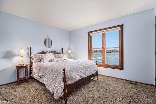 carpeted bedroom with visible vents and baseboards