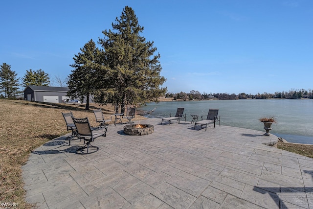 view of patio featuring a fire pit and a water view