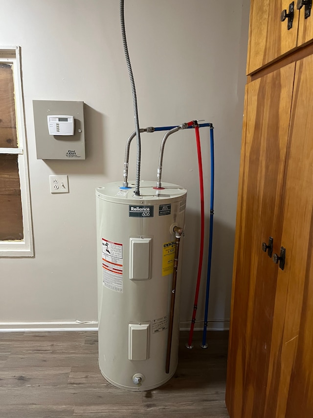 utility room featuring water heater