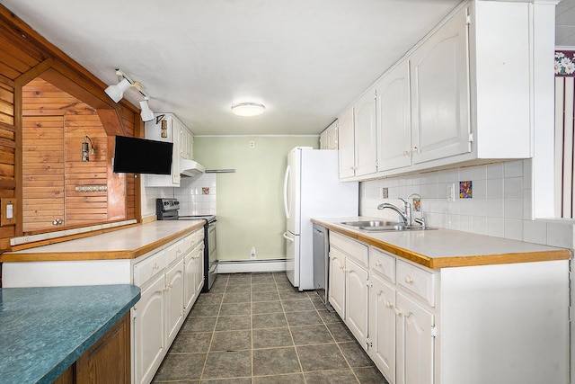 kitchen with backsplash, dark tile patterned floors, white cabinets, stainless steel appliances, and a sink