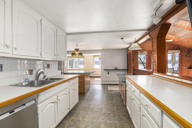 kitchen with a sink, white cabinets, stainless steel dishwasher, tasteful backsplash, and baseboard heating