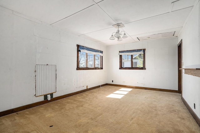 carpeted spare room featuring baseboards