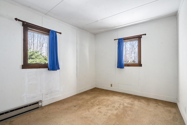 spare room featuring a baseboard radiator and carpet flooring