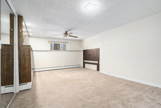 unfurnished room with baseboard heating, baseboards, carpet floors, and ceiling fan