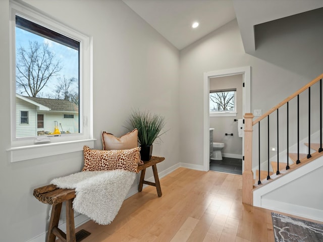 living area with baseboards, stairway, lofted ceiling, recessed lighting, and wood finished floors