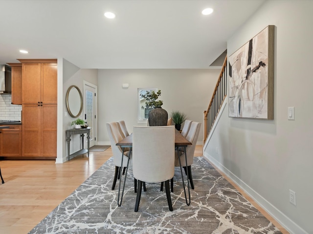 dining space featuring recessed lighting, stairs, baseboards, and wood finished floors