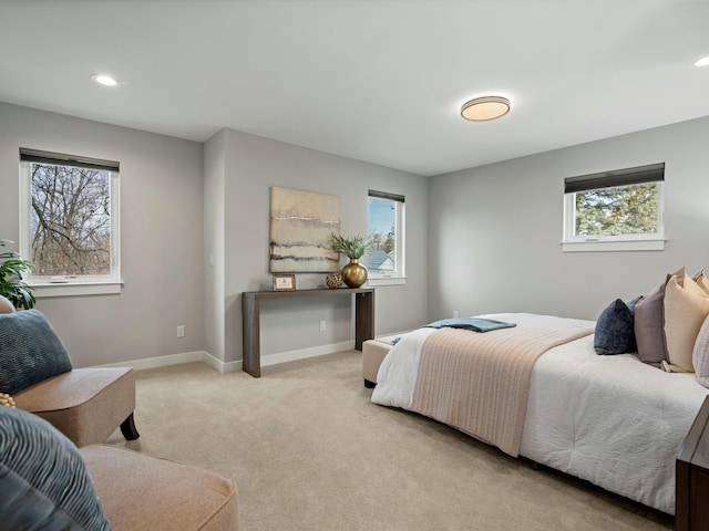 bedroom with recessed lighting, light colored carpet, and baseboards