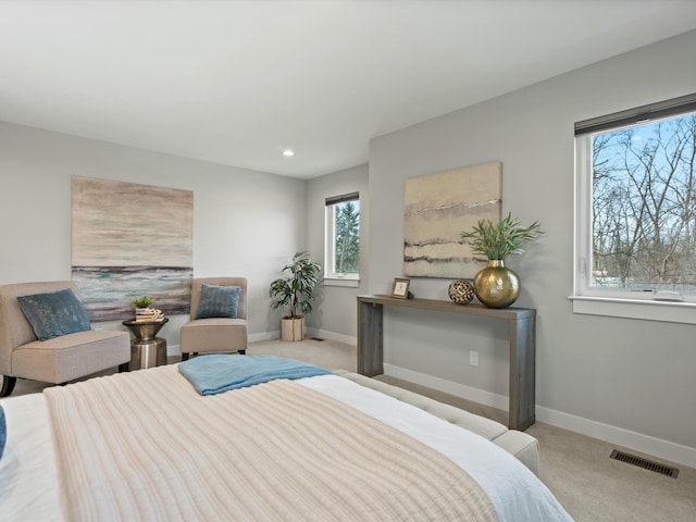 carpeted bedroom featuring recessed lighting, visible vents, and baseboards