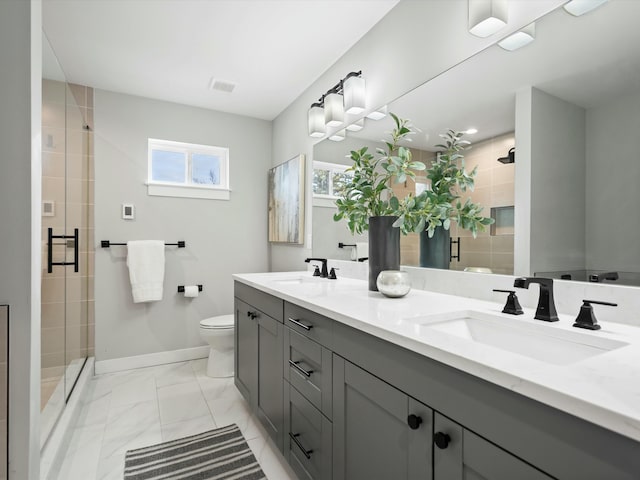 bathroom with baseboards, a stall shower, a sink, toilet, and marble finish floor