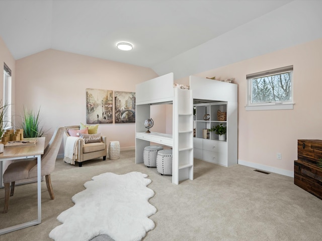 sitting room featuring baseboards, lofted ceiling, carpet floors, and visible vents