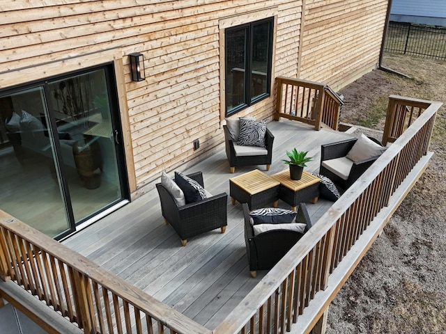 wooden deck with outdoor lounge area and fence