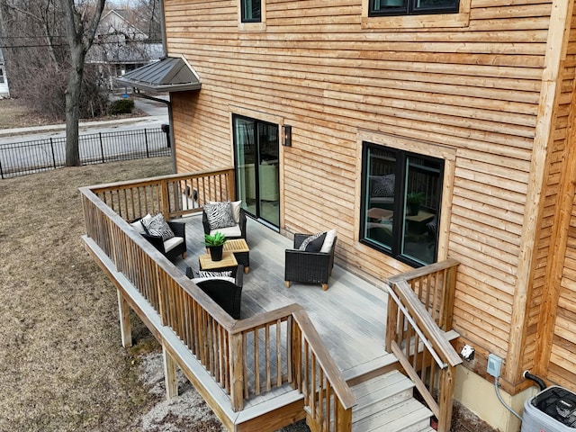 deck featuring an outdoor living space and fence